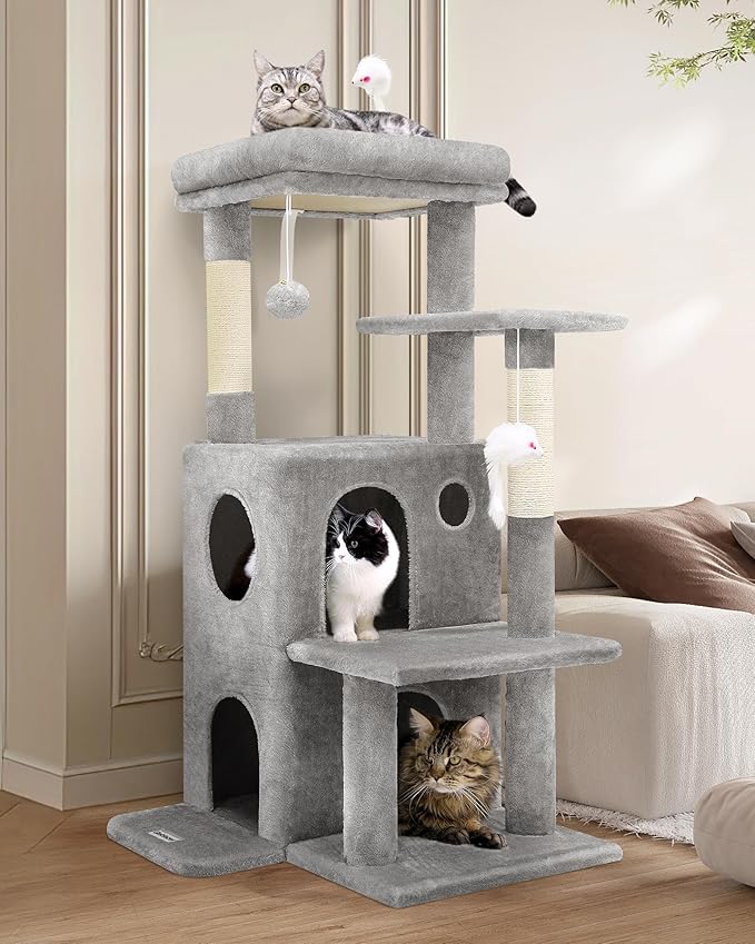 Multi-level cat tree with three cats lounging and playing — featured in the cat lover’s guide to creating the perfect indoor playground.